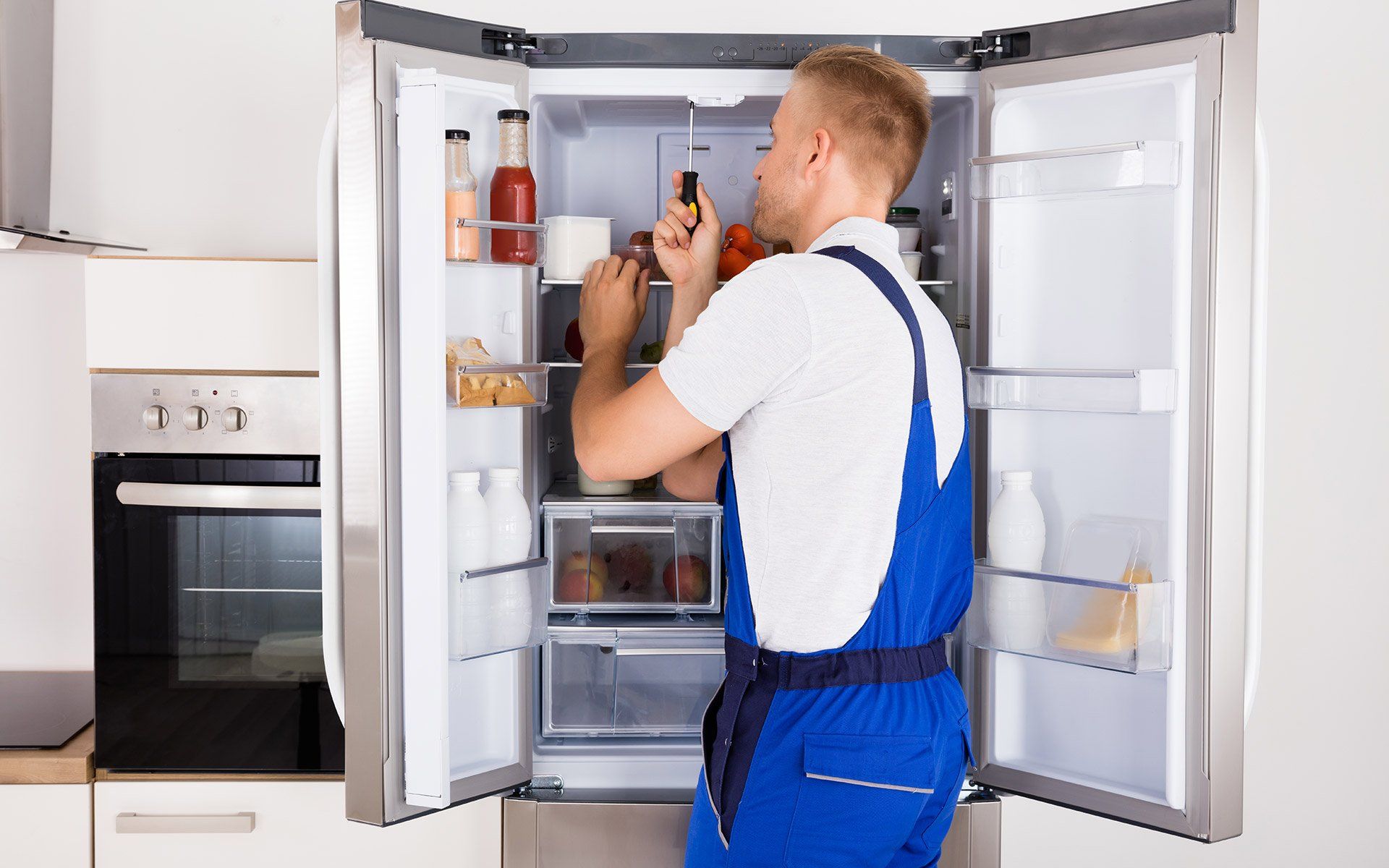 Man Repairing Refrigerator — Fairdale, KY — A + Appliance Repair